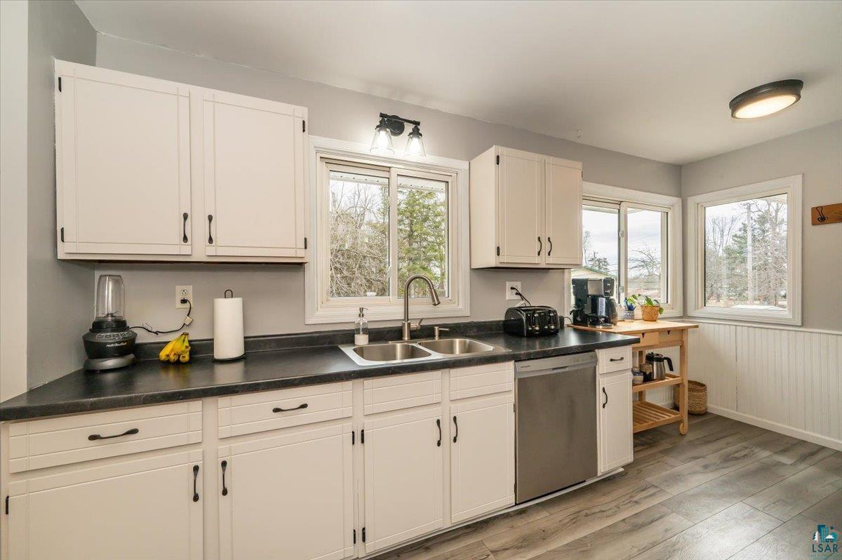 606 Maple Bend Drive Duluth, MN 55811 - Photo 6 of 30 Kitchen with dark countertops, stainless steel dishwasher