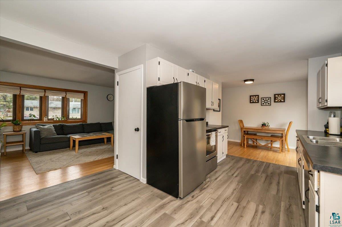 606 Maple Bend Drive Duluth, MN 55811 - Photo 8 of 30 Kitchen with a sink, white cabinetry, dark countertops, appliances with stainless steel finishes