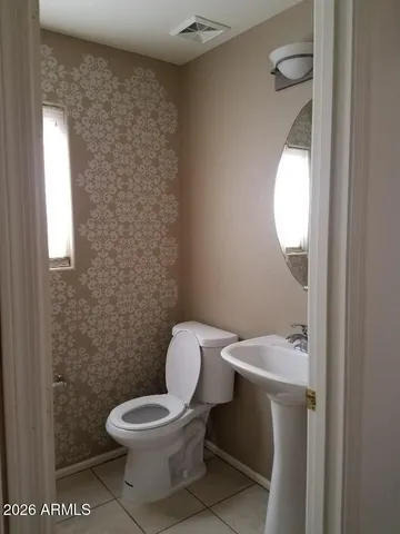 a white toilet sitting next to a bathroom sink