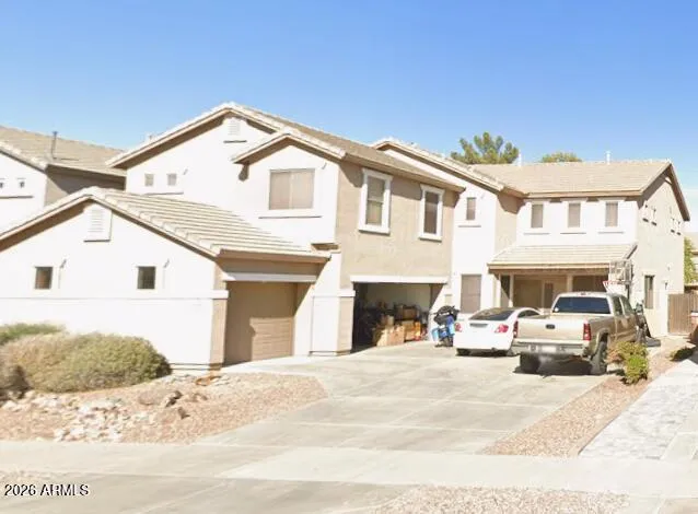 a view of building with cars parked
