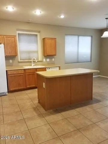 a large kitchen with stainless steel appliances a sink and a counter top space
