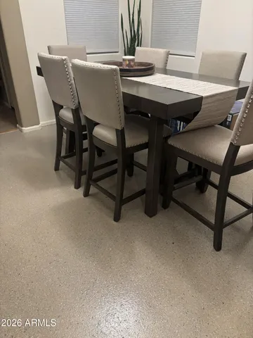 a view of a dining room with furniture and a table
