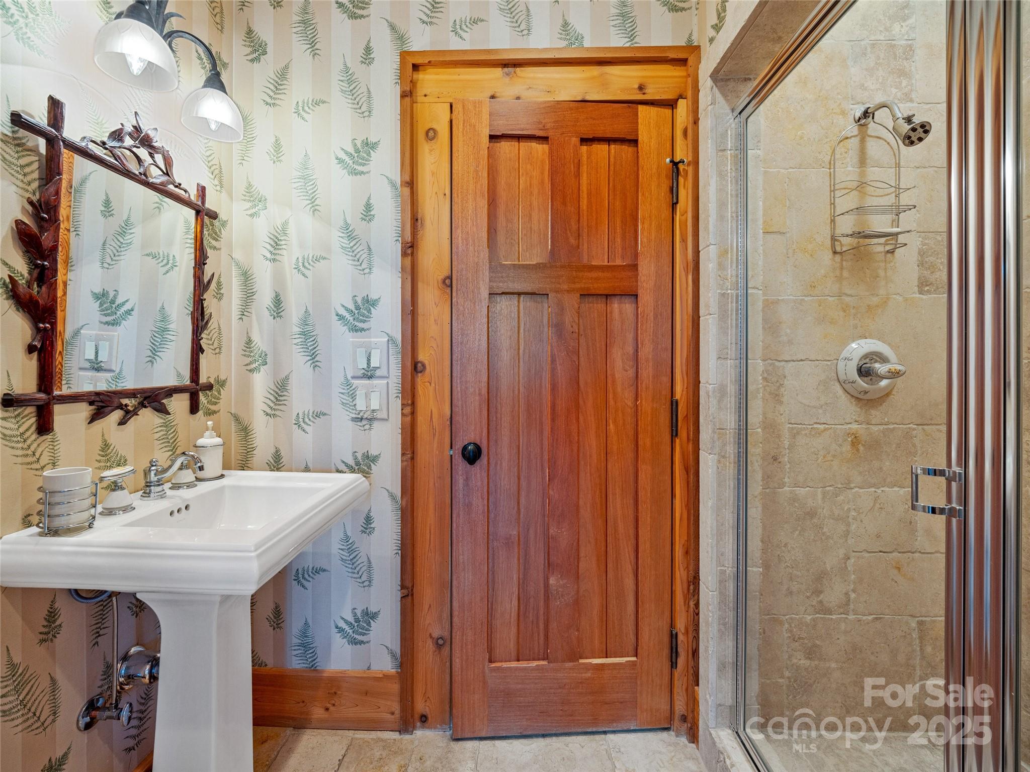 770 Mdw Rdg Drive Lake Toxaway, NC 28747 - Photo 17 of 48 a bathroom with a sink a mirror and a shower