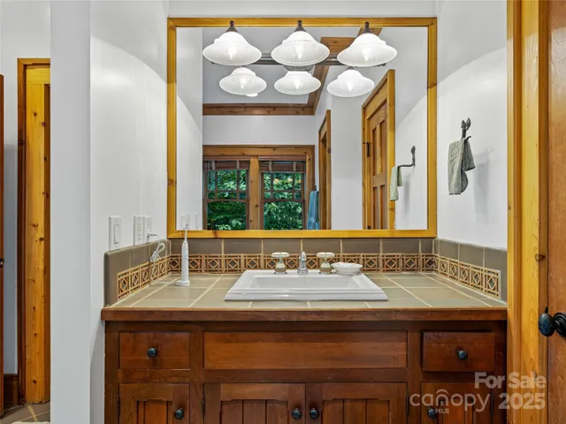 a bathroom with a sink a toilet and a mirror