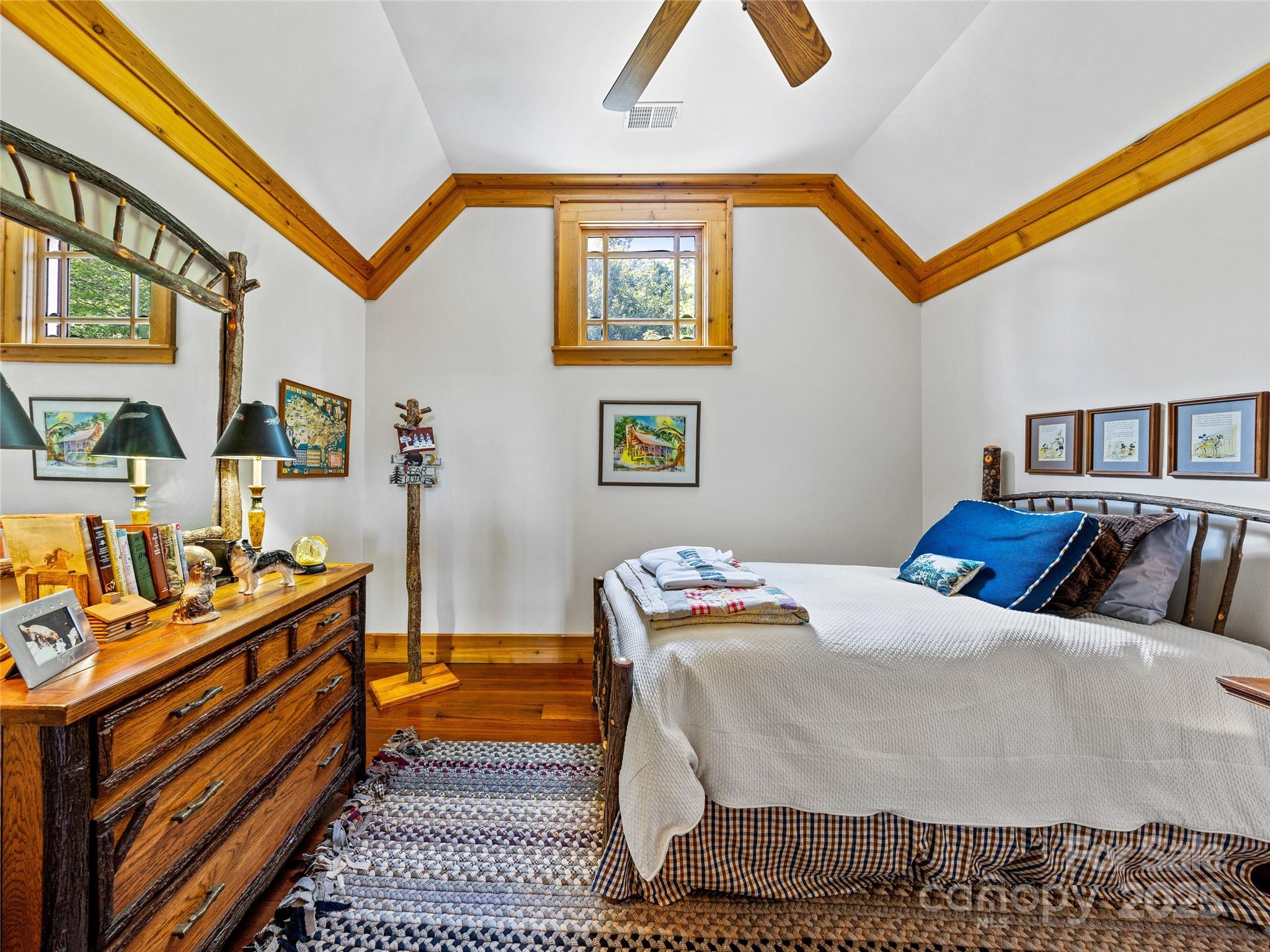 770 Mdw Rdg Drive Lake Toxaway, NC 28747 - Photo 29 of 48 a bedroom with a bed and wooden floor