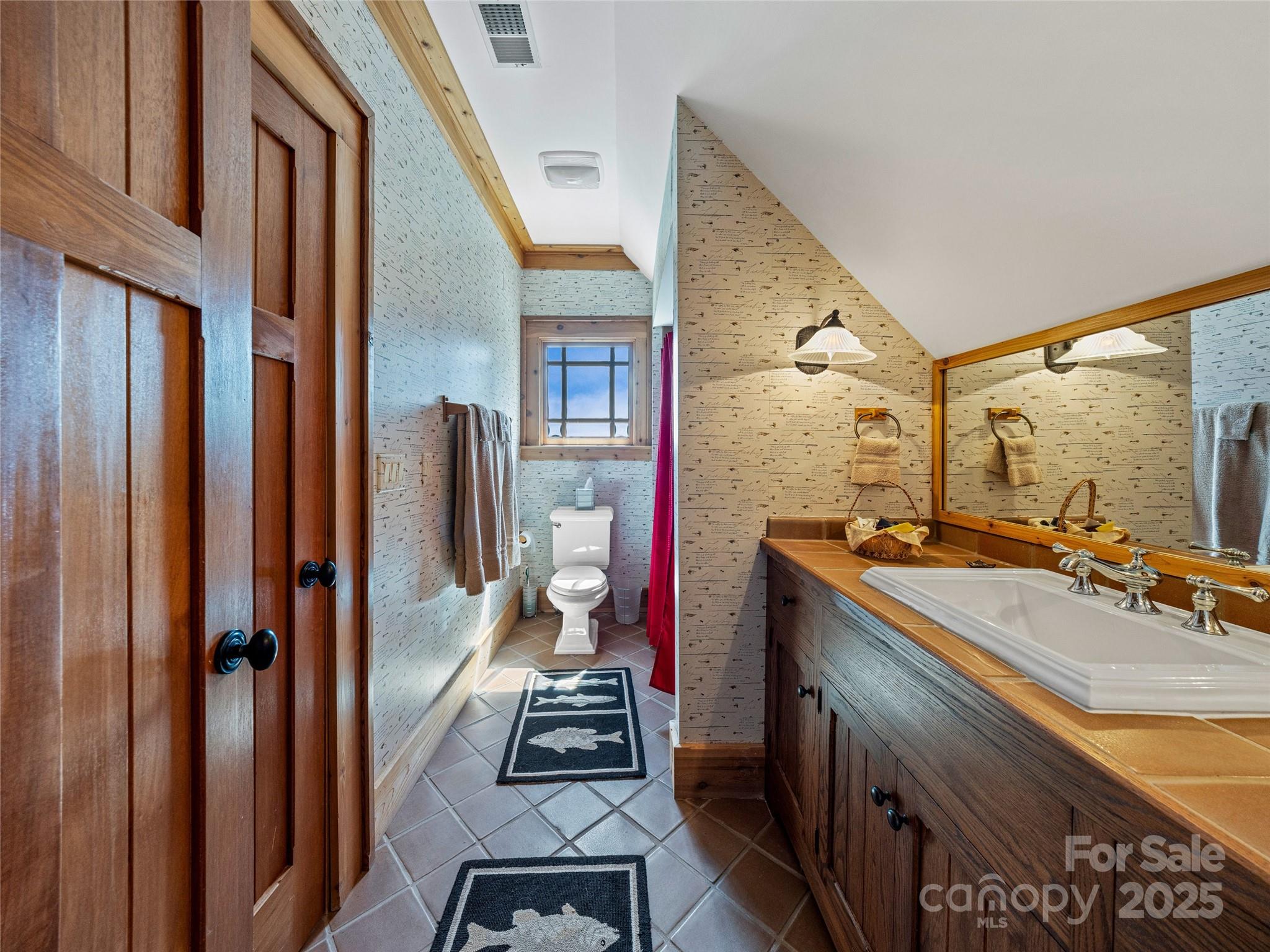770 Mdw Rdg Drive Lake Toxaway, NC 28747 - Photo 30 of 48 a bathroom with a sink vanity and mirror