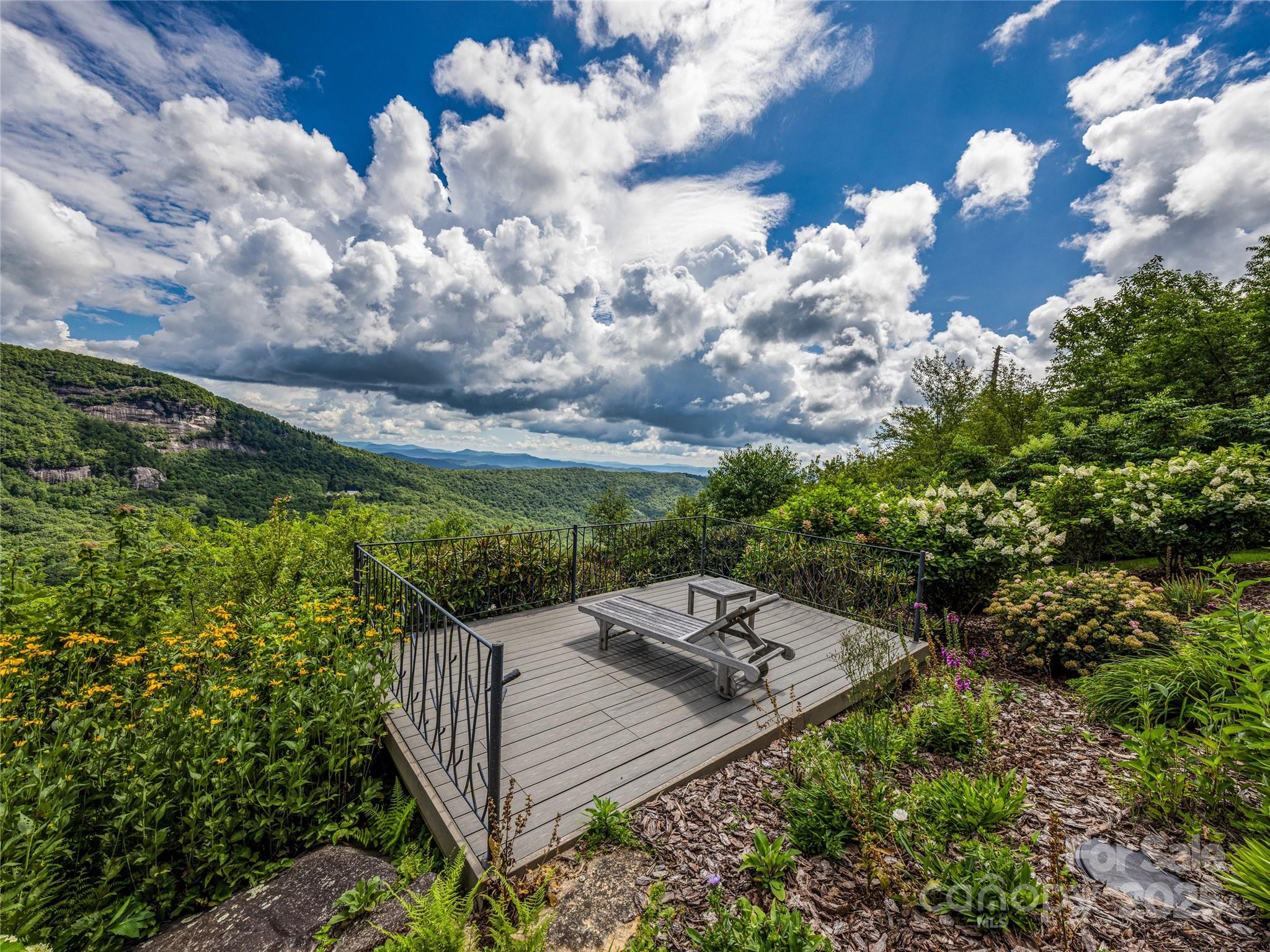 770 Mdw Rdg Drive Lake Toxaway, NC 28747 - Photo 41 of 48 a view of a backyard with brick wall