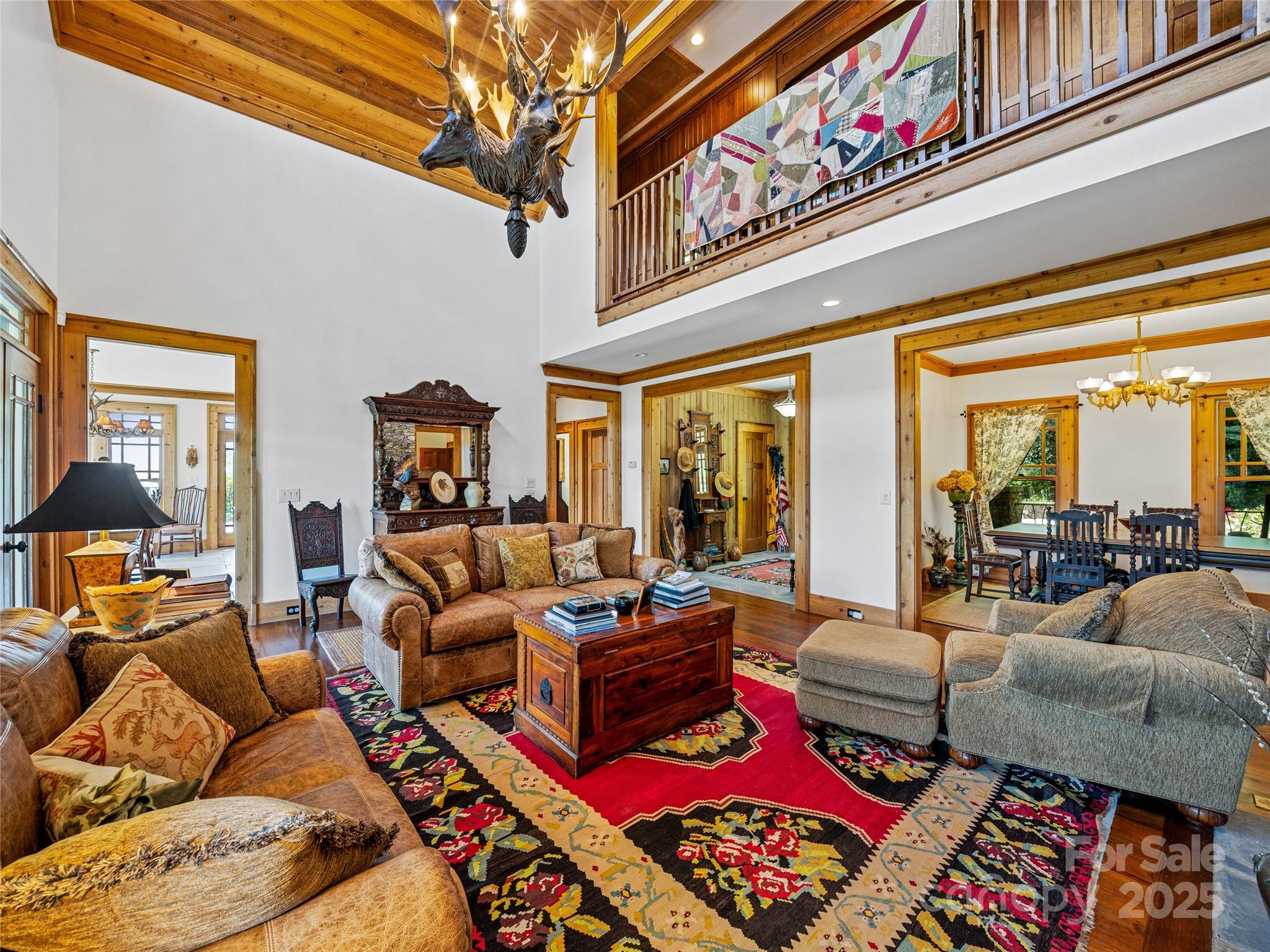 770 Mdw Rdg Drive Lake Toxaway, NC 28747 - Photo 10 of 48 a living room with furniture a rug and a large window