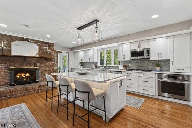 28 Spring Ridge Drive Berkeley Heights, NJ 07922 - Photo 15 of 46 a kitchen with stainless steel appliances granite countertop a stove a sink a microwave a refrigerator and a fireplace
