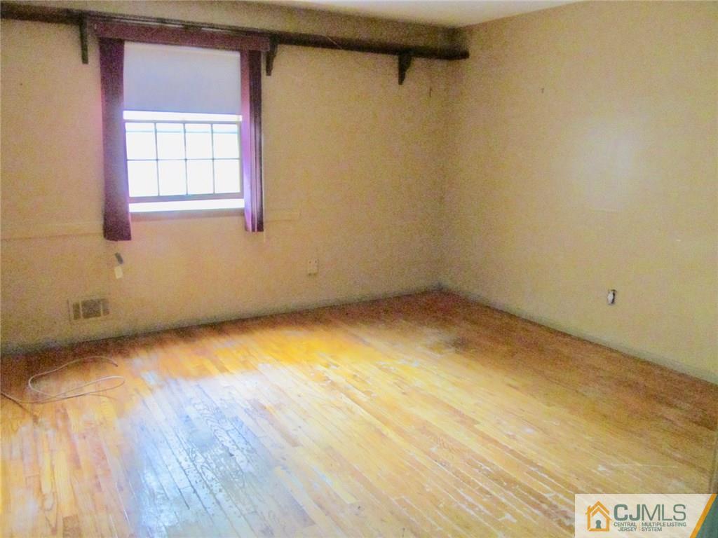 12 Kings Road East Brunswick, NJ 08816 - Photo 15 of 24 a view of a room that has wooden floor and a window