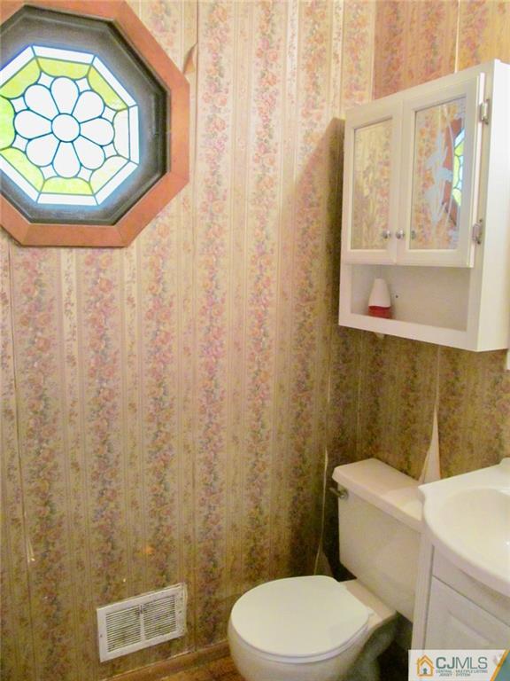 12 Kings Road East Brunswick, NJ 08816 - Photo 8 of 24 a bathroom with a toilet and a sink