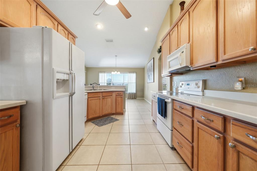 17083 Southeast 115th Terrace Road Summerfield, FL 34491 - Photo 13 of 61 a kitchen with stainless steel appliances granite countertop a refrigerator and a sink