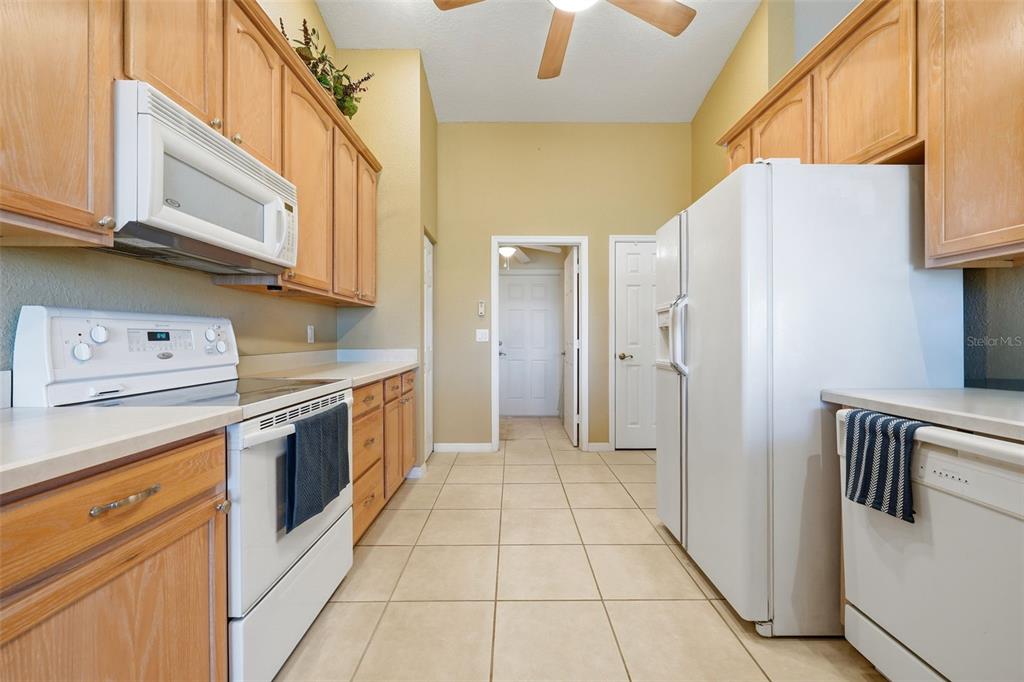 17083 Southeast 115th Terrace Road Summerfield, FL 34491 - Photo 14 of 61 a kitchen with stainless steel appliances granite countertop a refrigerator a stove and a sink