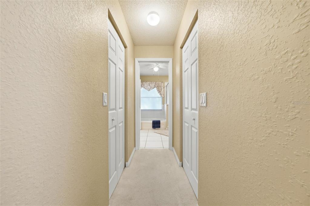 17083 Southeast 115th Terrace Road Summerfield, FL 34491 - Photo 22 of 61 a view of a hallway with wooden floor and a bathroom