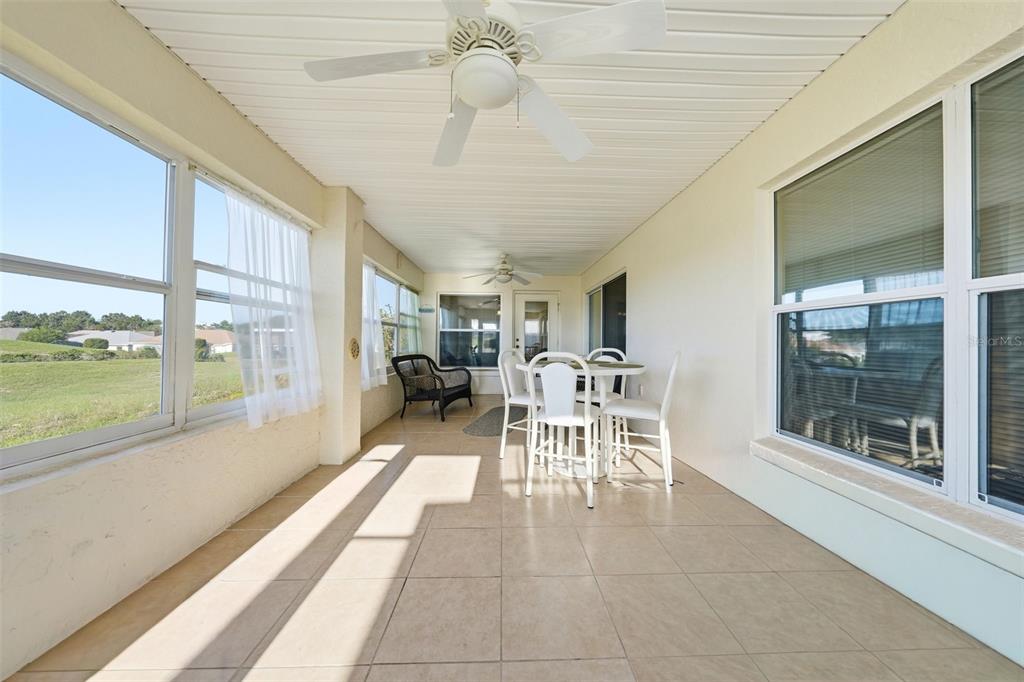 17083 Southeast 115th Terrace Road Summerfield, FL 34491 - Photo 35 of 61 a dining room with furniture water view and a floor to ceiling window
