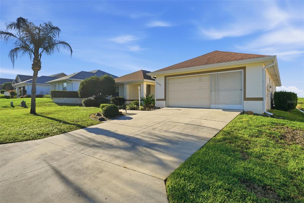 17083 Southeast 115th Terrace Road Summerfield, FL 34491 - Photo 43 of 61 a front view of a house with a yard and garage