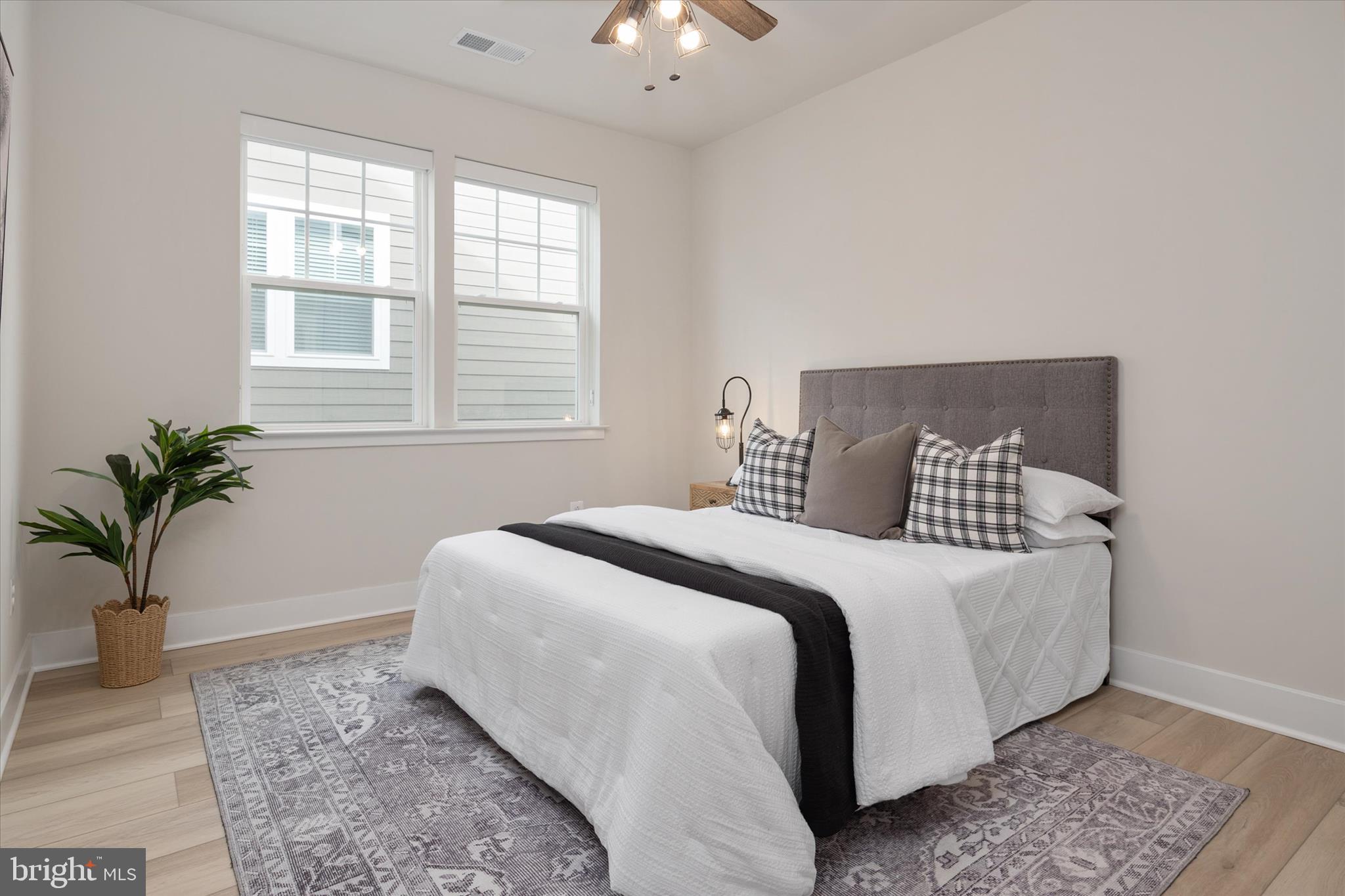 143 Stilly Way Annapolis, MD 21403 - Photo 22 of 60 a bedroom with a large bed and a potted plant