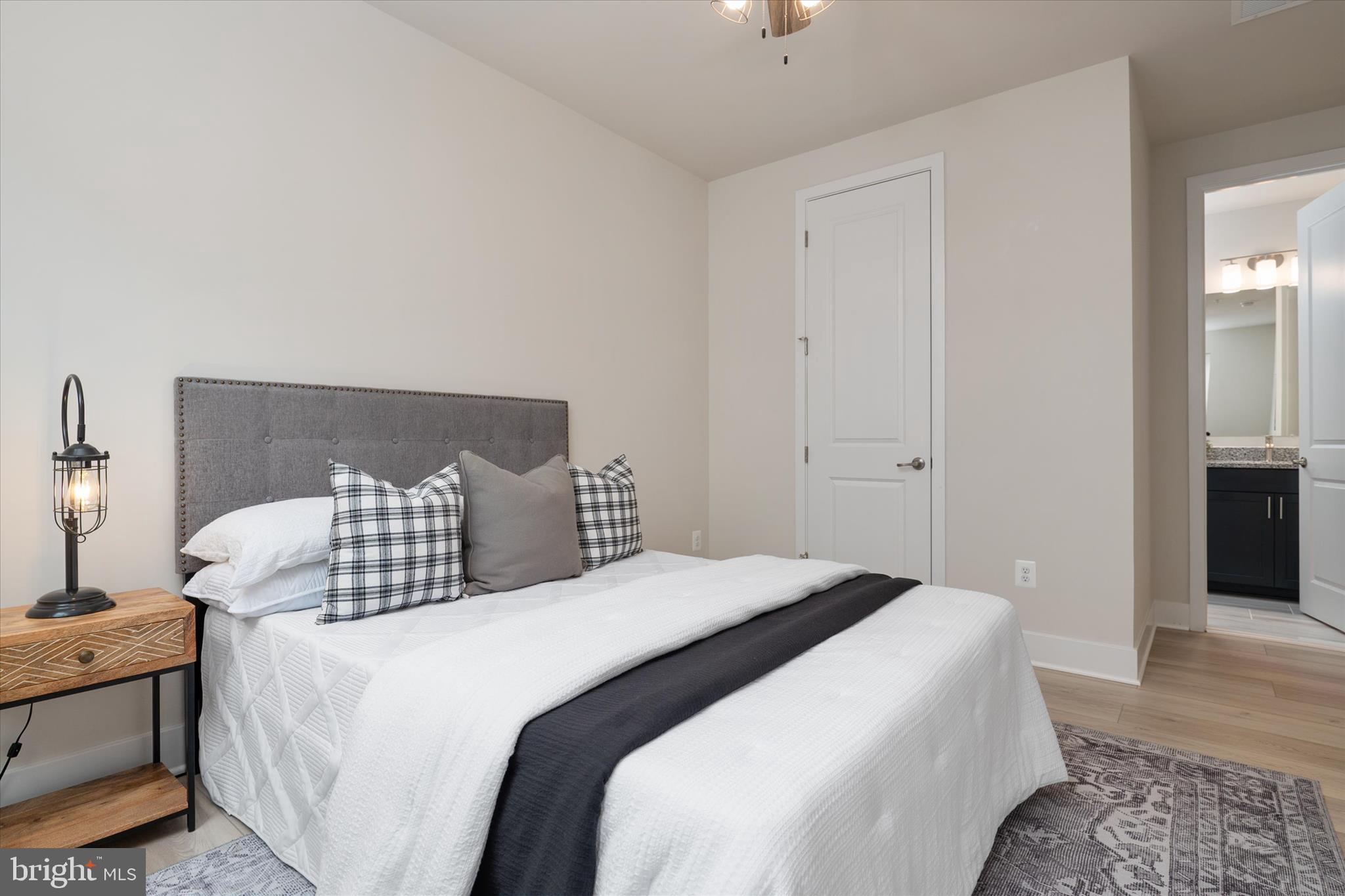 143 Stilly Way Annapolis, MD 21403 - Photo 23 of 60 a bedroom with a bed and wooden floor