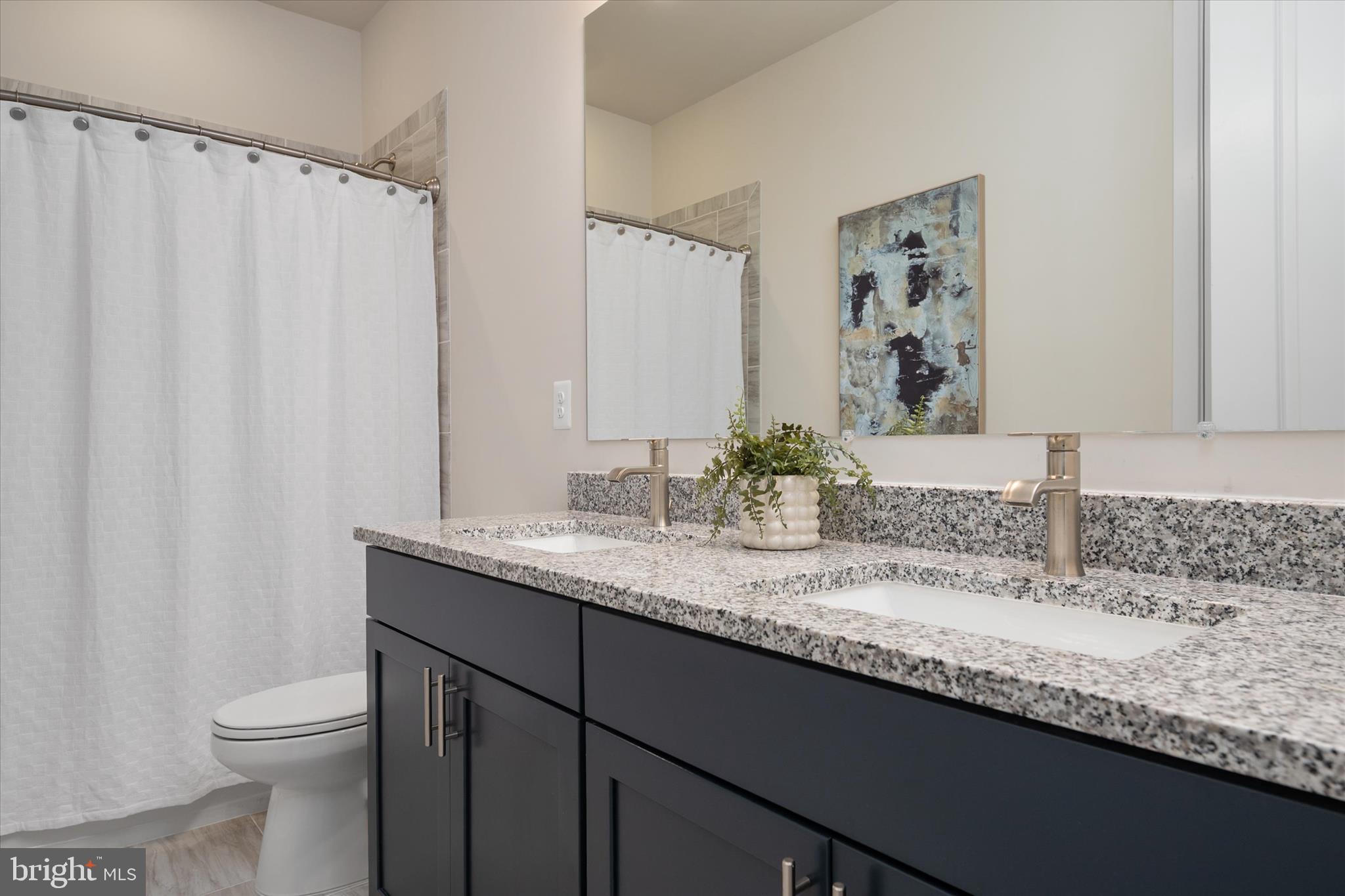 143 Stilly Way Annapolis, MD 21403 - Photo 24 of 60 a bathroom with a granite countertop sink and a mirror