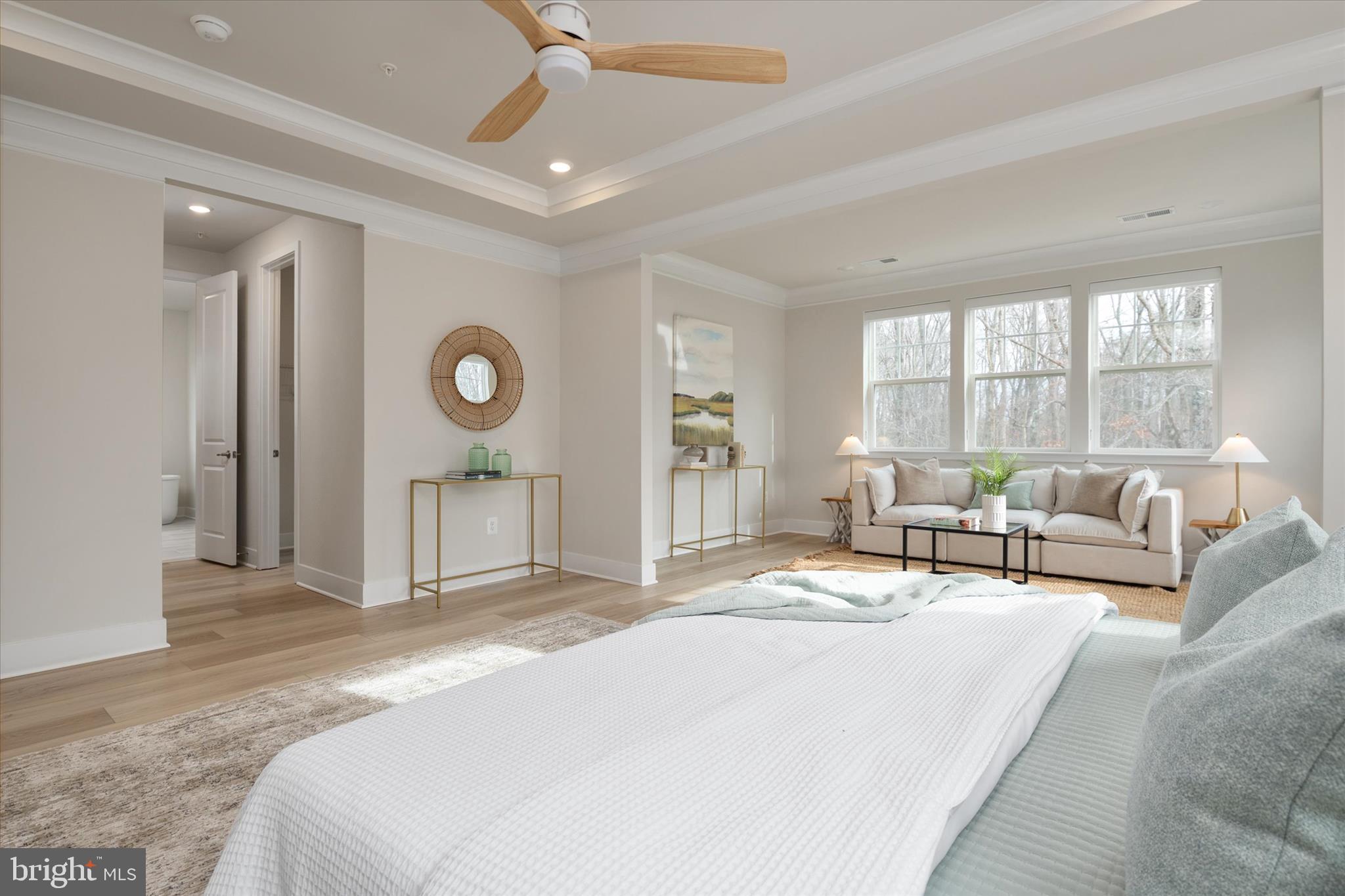 143 Stilly Way Annapolis, MD 21403 - Photo 26 of 60 a spacious bedroom with a bed a couch and large window