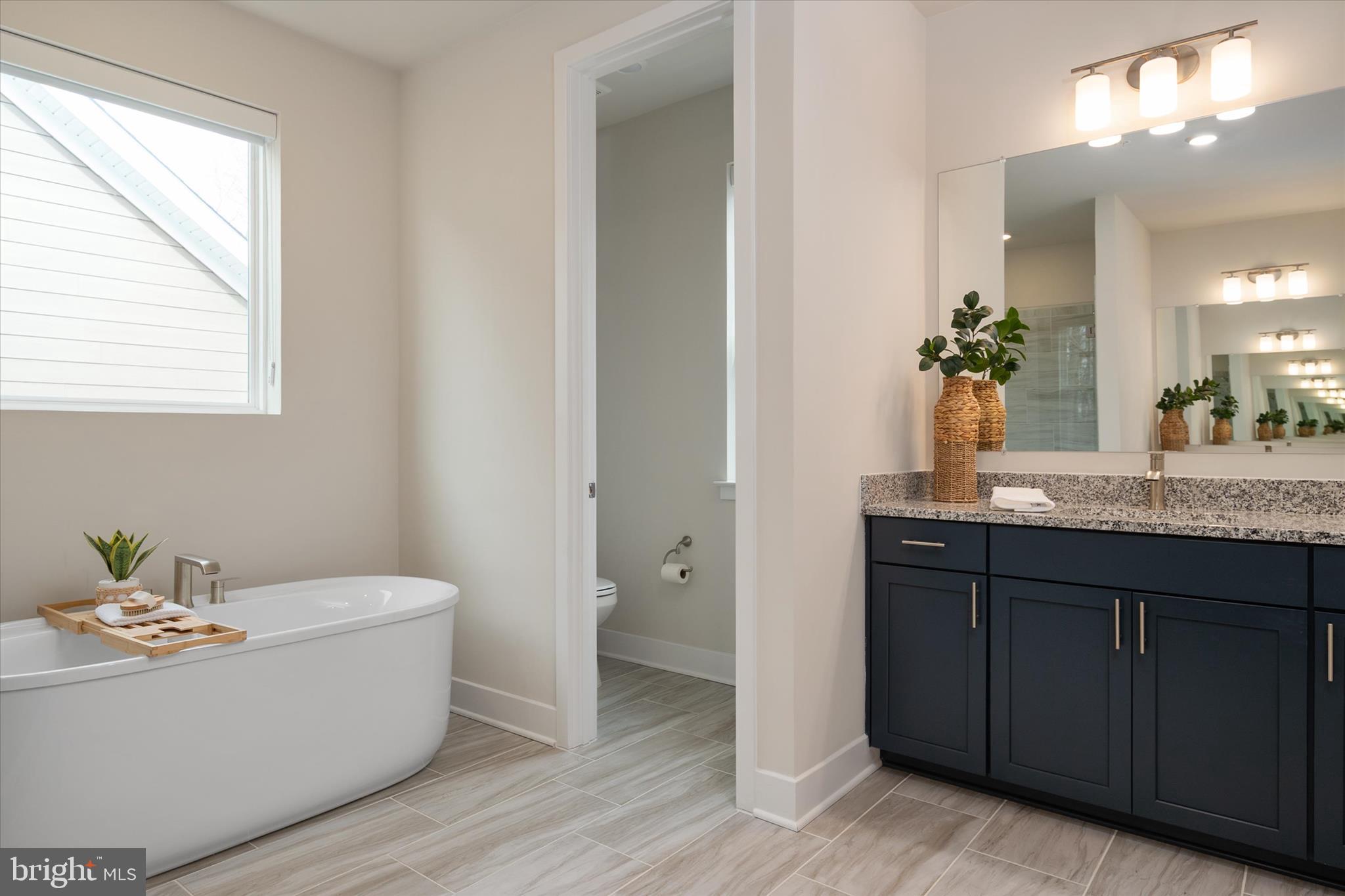 143 Stilly Way Annapolis, MD 21403 - Photo 29 of 60 a bathroom with a tub a sink and mirror