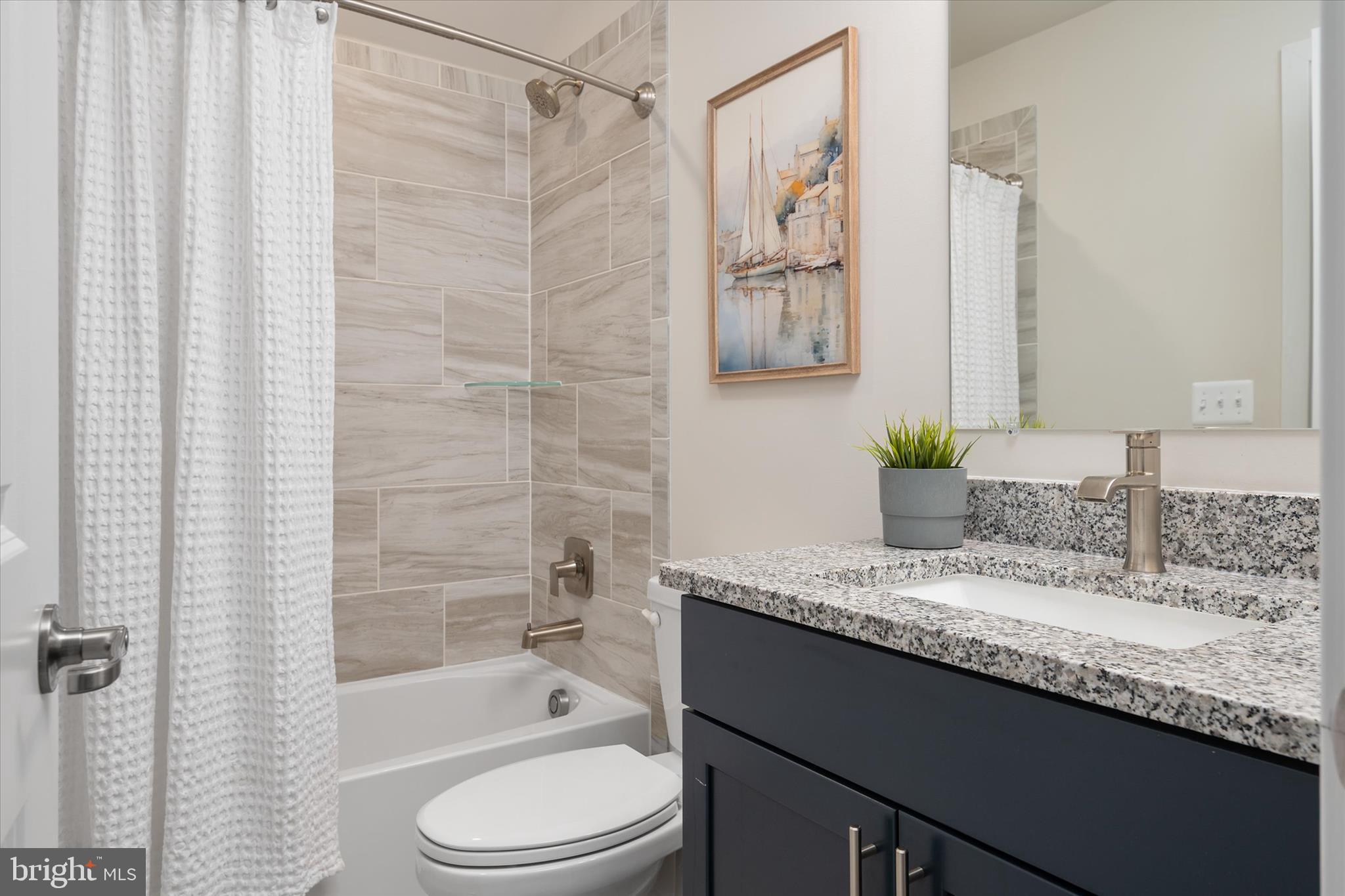 143 Stilly Way Annapolis, MD 21403 - Photo 35 of 60 a bathroom with a granite countertop sink a toilet and shower