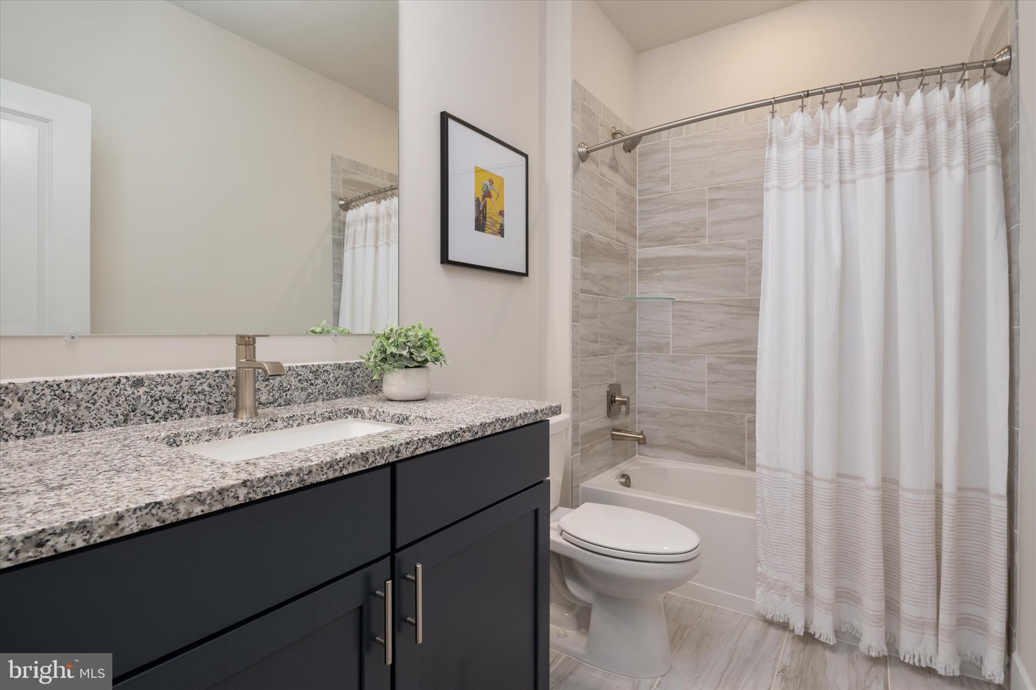 143 Stilly Way Annapolis, MD 21403 - Photo 38 of 60 a bathroom with a granite countertop sink a toilet and shower