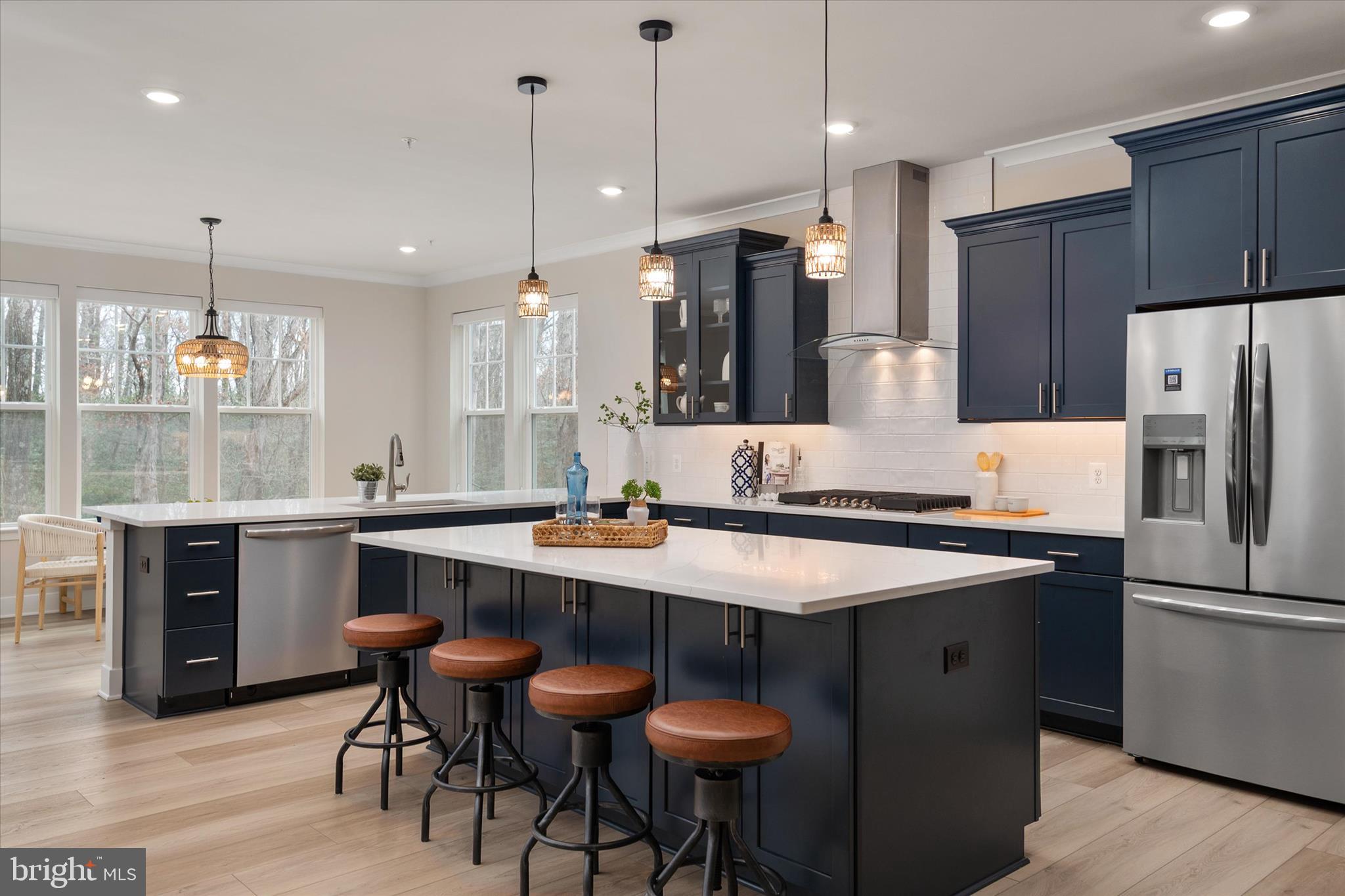 143 Stilly Way Annapolis, MD 21403 - Photo 7 of 60 a kitchen with stainless steel appliances granite countertop a sink a stove a refrigerator and chairs