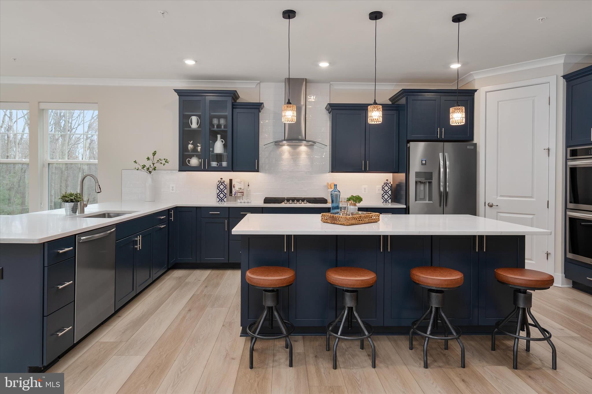 143 Stilly Way Annapolis, MD 21403 - Photo 8 of 60 a kitchen with a dining table chairs stainless steel appliances and cabinets