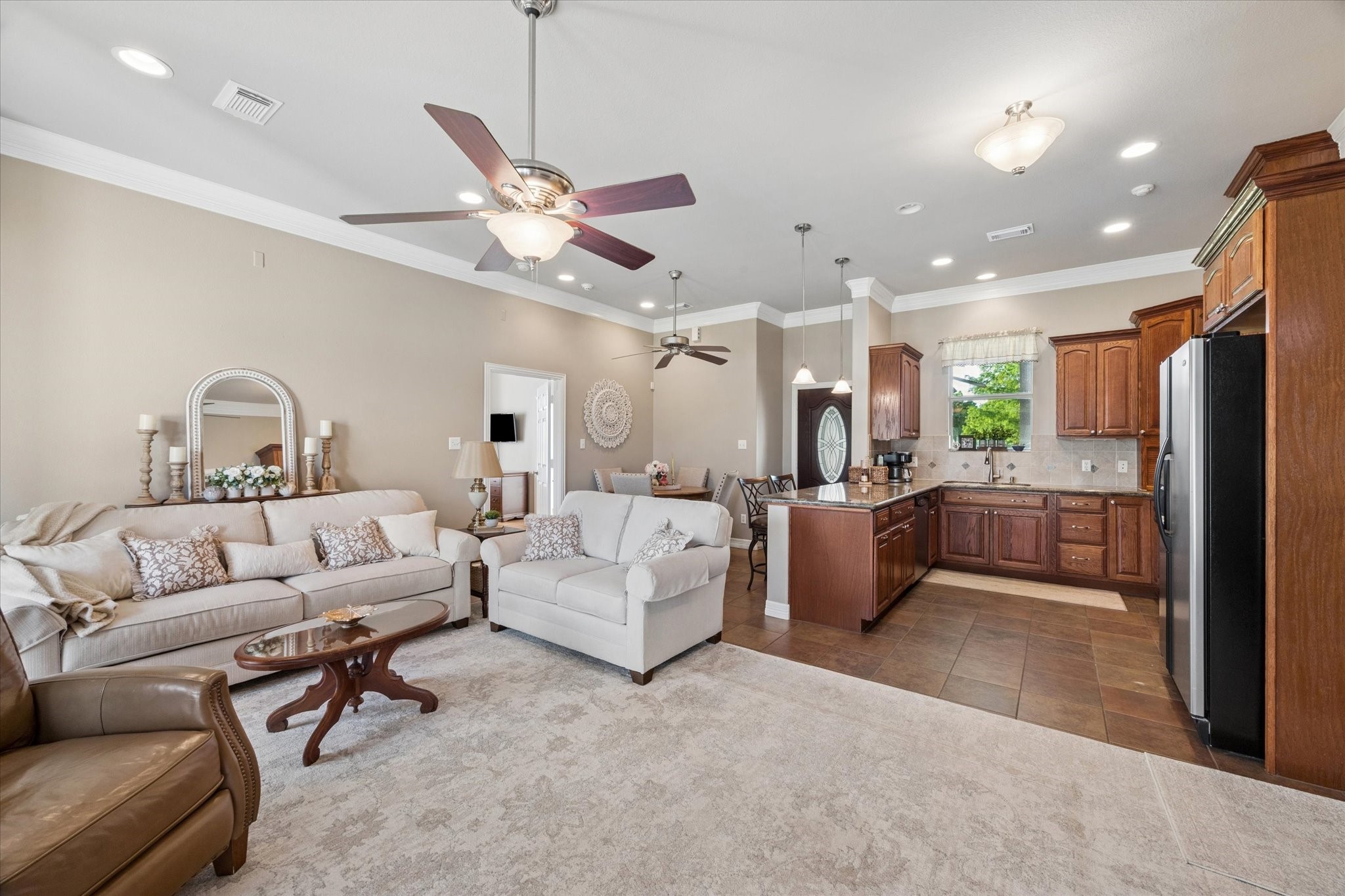 16519 Deerhaven Run Rosharon, TX 77583 - Photo 30 of 47 a living room with furniture kitchen view and a chandelier