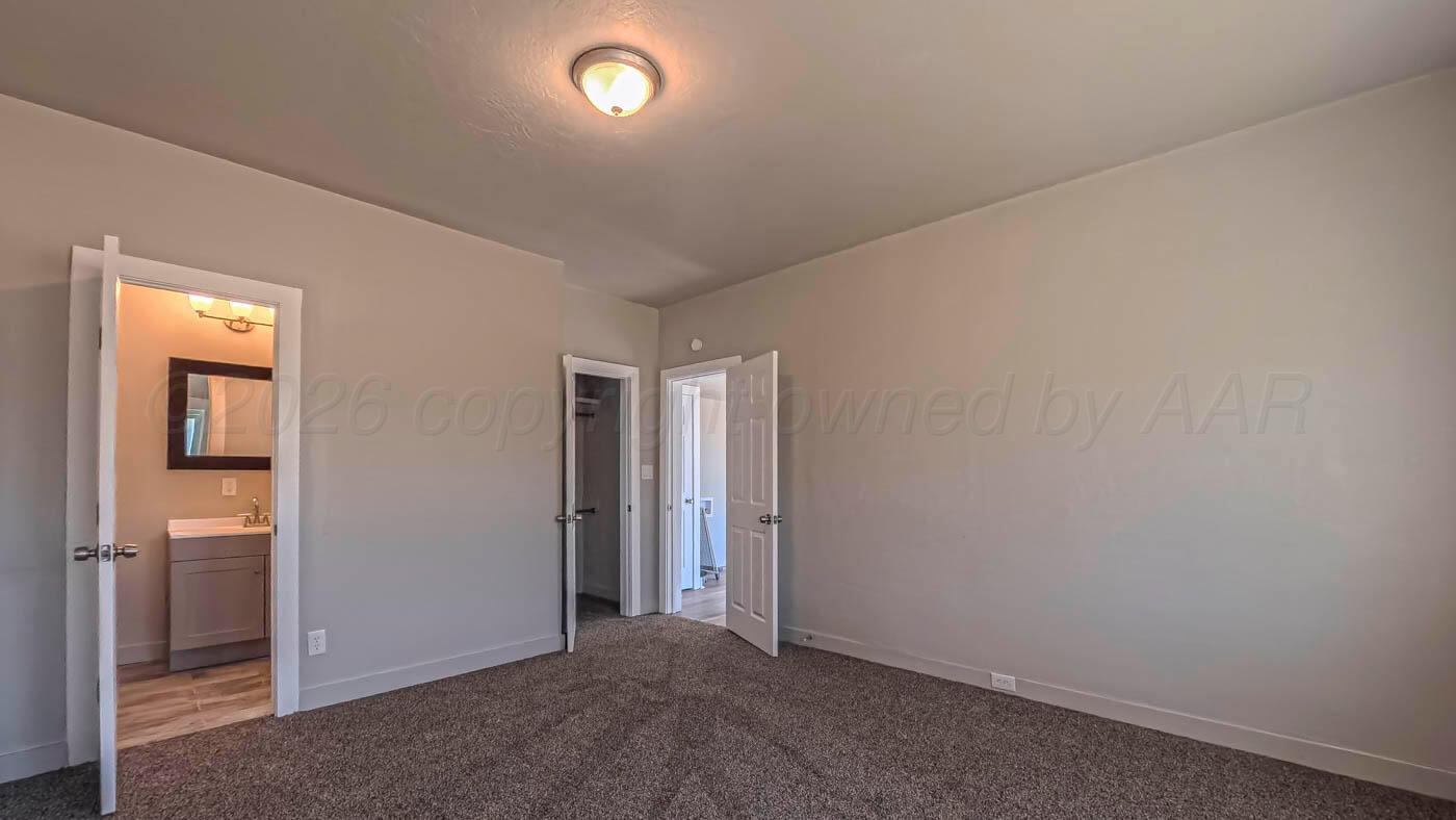 1316 Withers Avenue Amarillo, TX 79108 - Photo 9 of 19 an empty room with closet and mirror