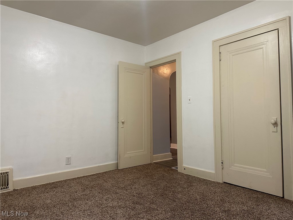 7954 Warren - Sharon Road Masury, OH 44438 - Photo 12 of 28 Unfurnished bedroom with dark carpet and arched walkways
