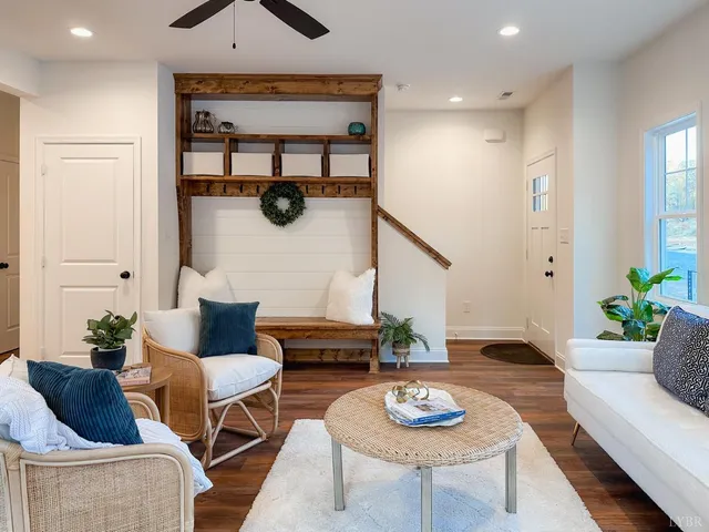 a living room with furniture and wooden floor
