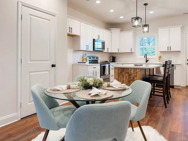 a dining room with furniture and wooden floor
