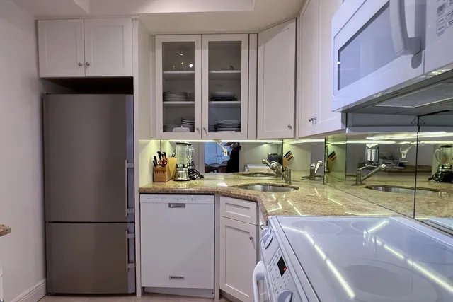 a kitchen with a refrigerator and a sink