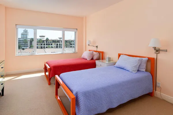 a bedroom with a bed and a large window