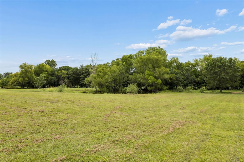 62 Trail Ridge Drive Melissa, TX 75454 - Photo 32 of 39 View of the large pond with beautiful trees and a creek runs behind
