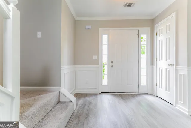 an empty room with wooden floor and a fireplace