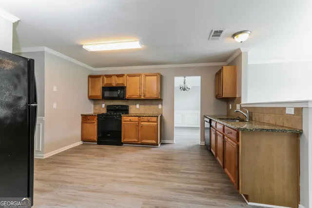 a kitchen with stainless steel appliances a refrigerator and a stove top oven