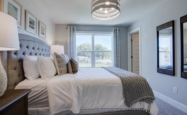 a bedroom with a large bed and a window