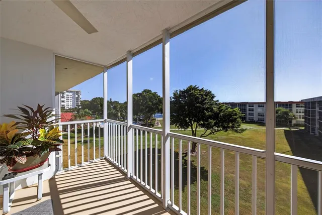 a view of roof deck with wooden floor and fence