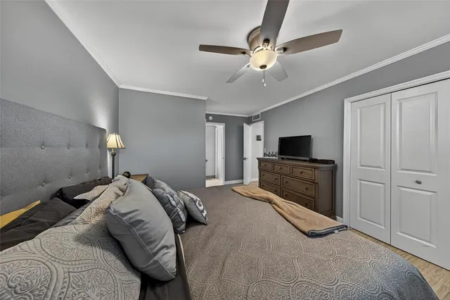 a bed room with a bed a television and dresser