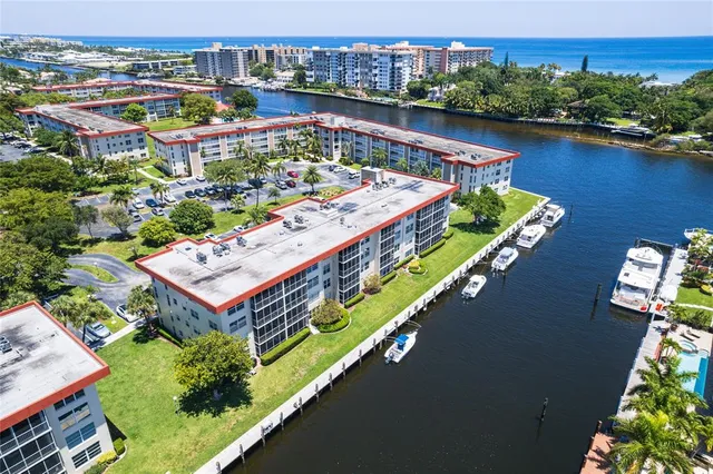 an aerial view of a house with a garden and lake view