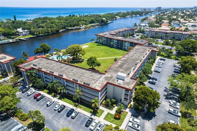 an aerial view of a house with a garden and lake view