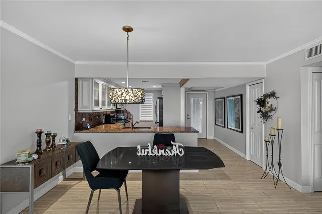 a view of a dining room with furniture and chandelier
