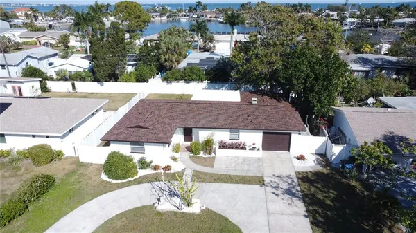 an aerial view of a house with a yard and lake view