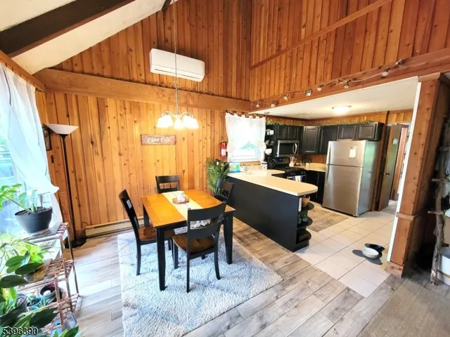 a kitchen with stainless steel appliances a refrigerator a stove a sink and a refrigerator