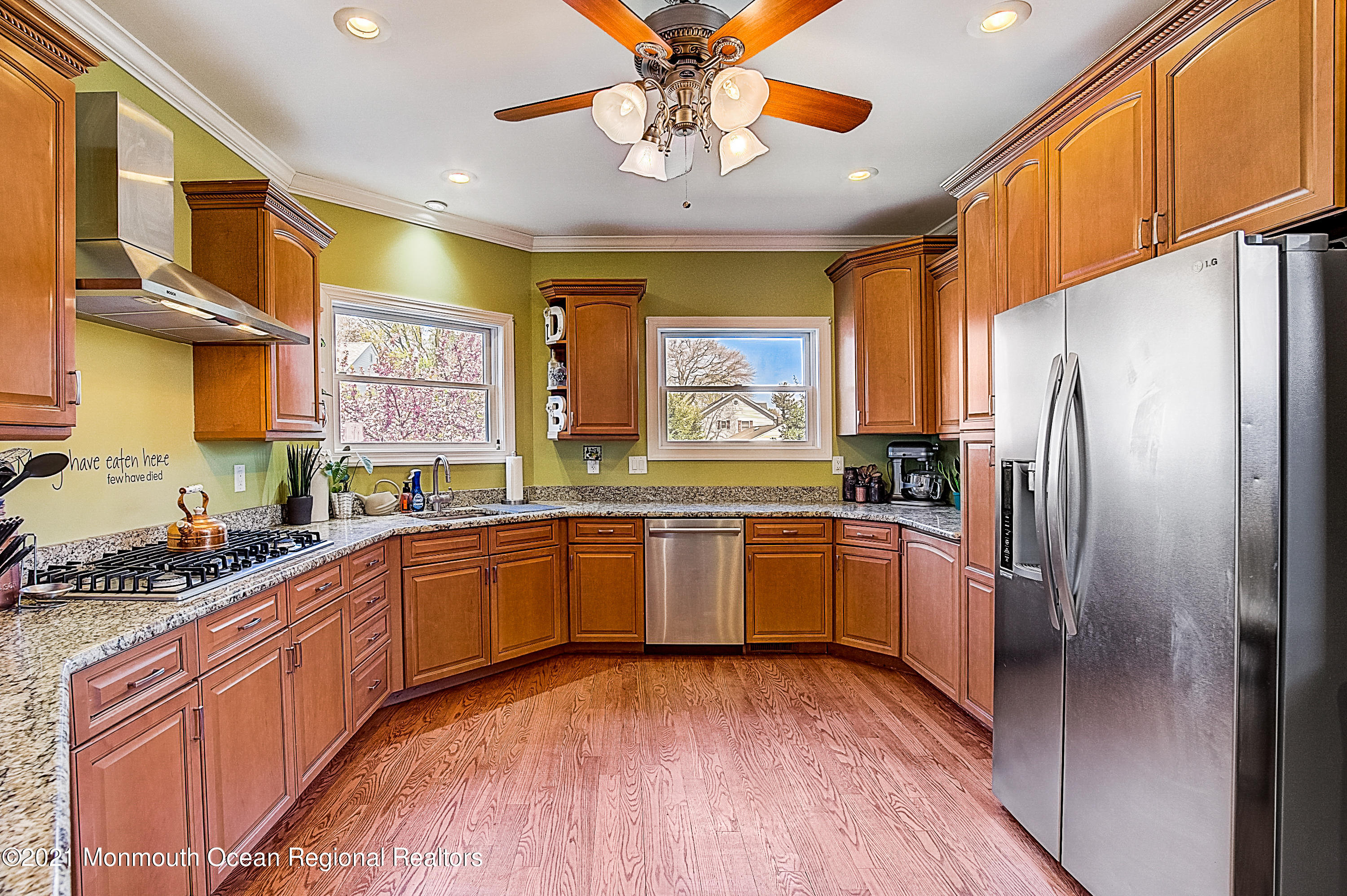 286 Main Street Middletown, NJ 07758 - Photo 21 of 69 a kitchen with stainless steel appliances granite countertop a refrigerator a sink dishwasher a stove and a dining table with wooden floor