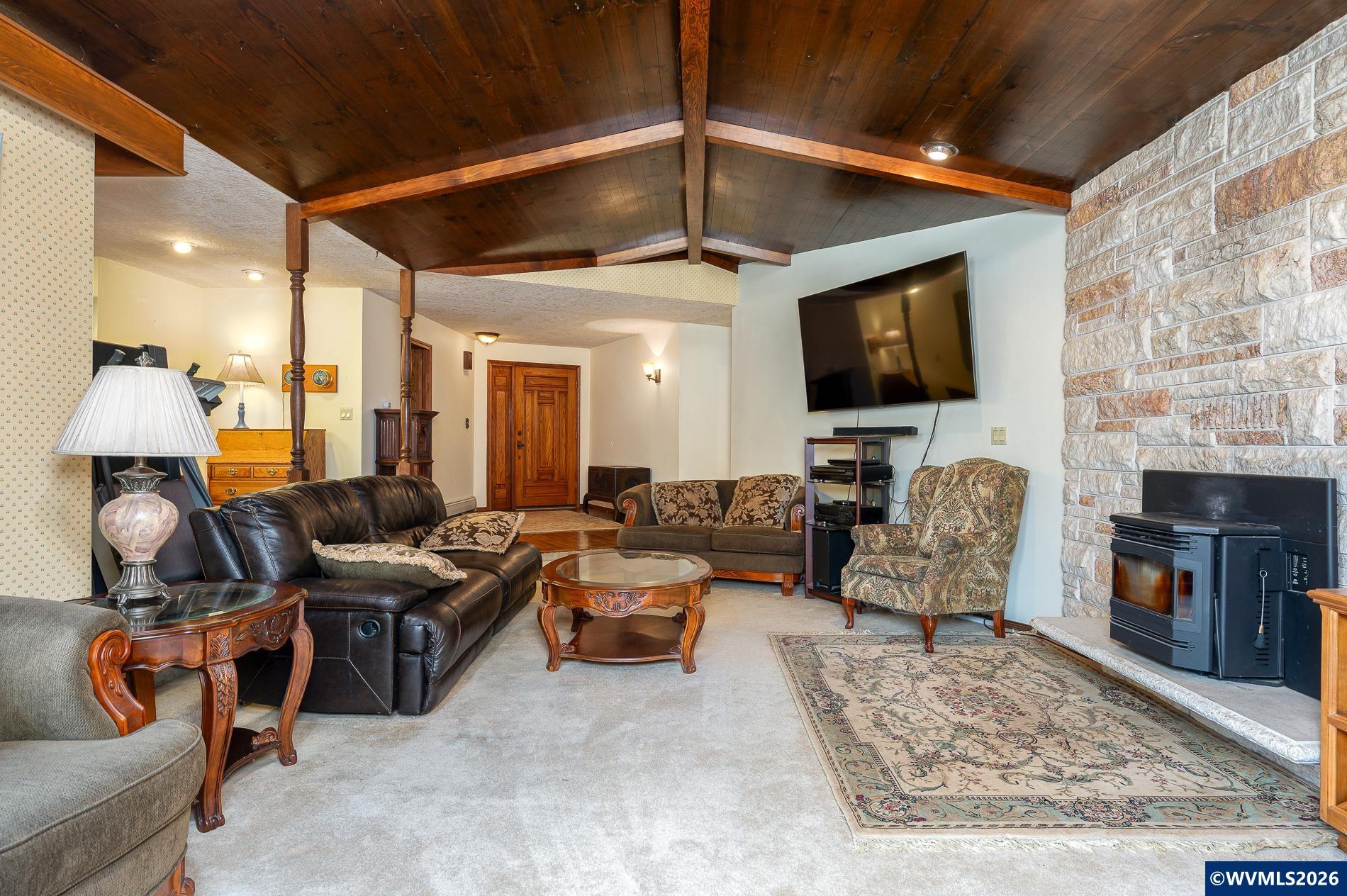 27572 South Kinzy Road Estacada, OR 97023 - Photo 11 of 50 a living room with furniture a flat screen tv and a fireplace