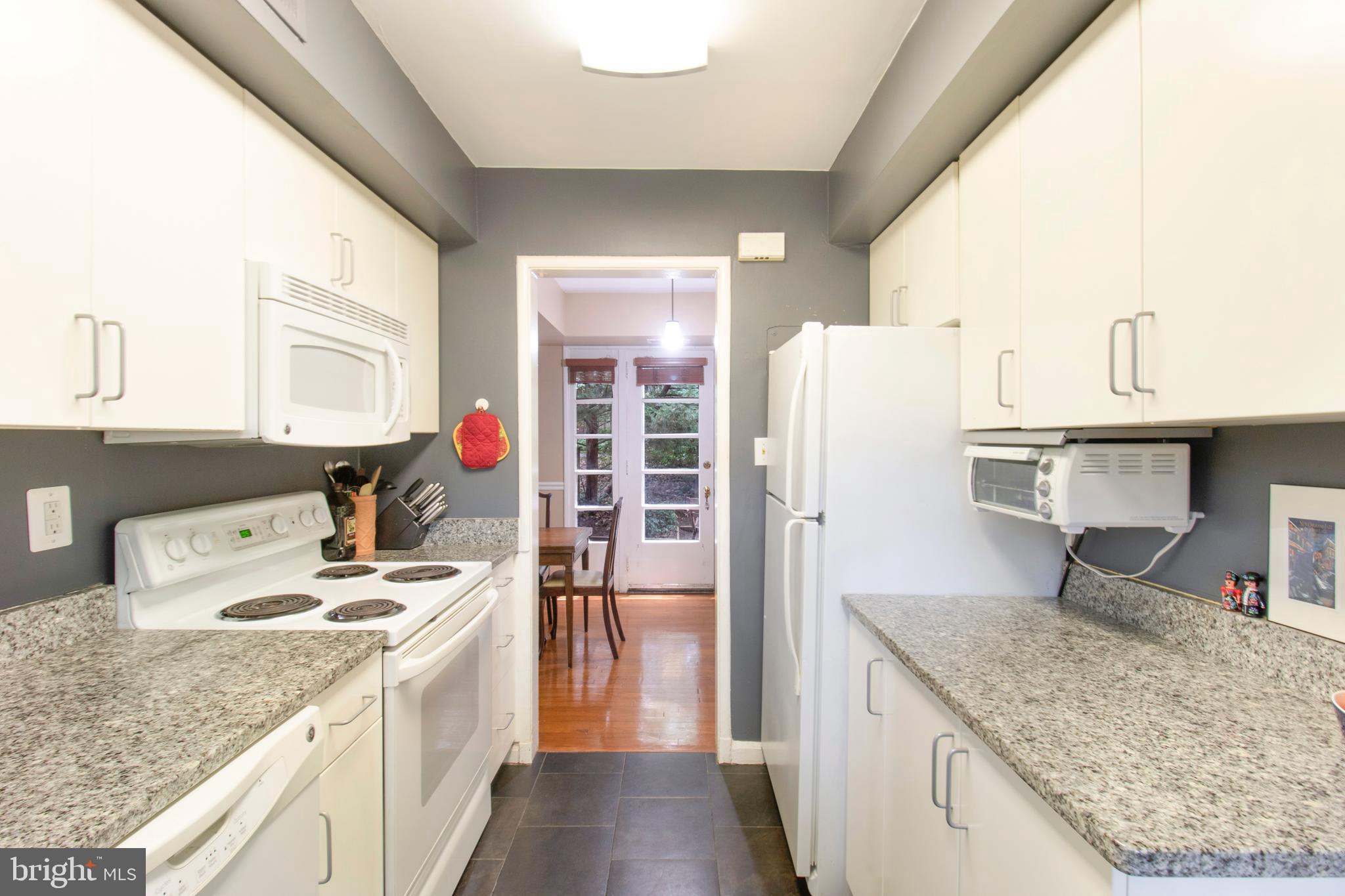 8512-12-2 Manchester Road, Unit 122 Silver Spring, MD 20901 - Photo 12 of 40 Kitchen view through DR into back patio/yard